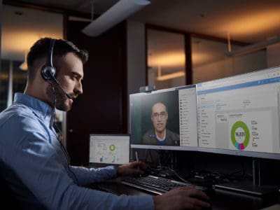 Man using Microsoft 365 business voice to connect with his team remotely.